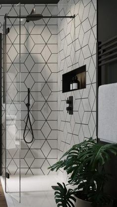 a bathroom with a walk in shower next to a plant