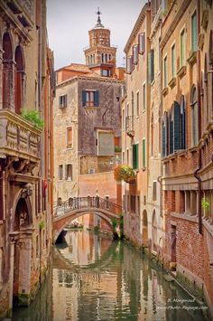 a narrow canal runs through an old city