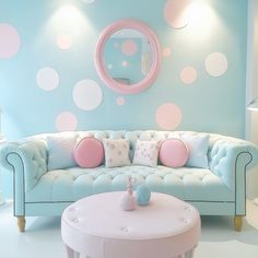 a living room decorated in pastel blue and pink with polka dots on the wall