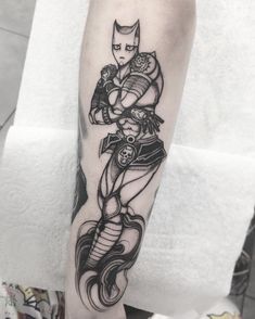 a woman's leg with a tattoo on it that has an image of a catwoman