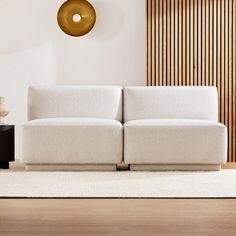 a white couch sitting on top of a wooden floor