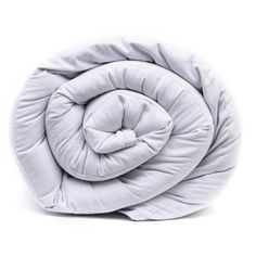 an image of a white comforter that is rolled up on top of each other