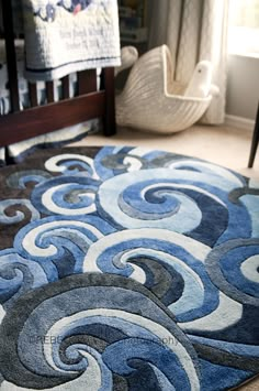 an area rug with blue and white swirls on it