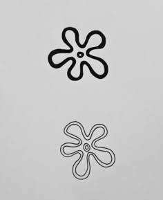 two black and white flowers on a light gray background, one with an upside down design