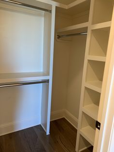 an empty walk in closet with white walls and open shelving unit on the floor