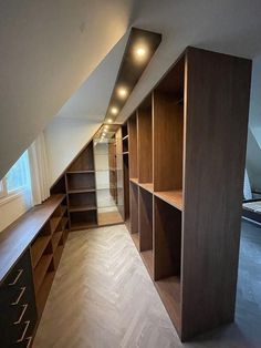 an attic bedroom with built in shelving units