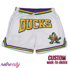 Mighty Ducks Hockey Goldberg Disney Retro Mesh Shorts Throwback Style Sports Shorts, Team Spirit Shorts With Built-in Shorts For Sports Season, Sporty Shorts With Team Name For Sports Events, Collegiate White Bottoms For Sports Events, White Team Spirit Athletic Shorts For Sports, White Athletic Shorts For Sports With Team Spirit, White Cotton Cheerleading Bottoms, White Shorts For Cheerleading, White Letter Print Bottoms For Sports Season