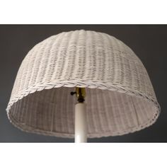 a white wicker lamp shade on a table