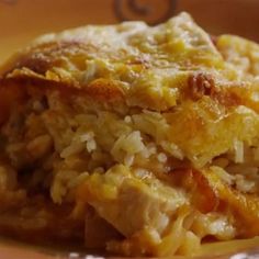 a close up of a plate of food with rice and chicken casserole on it