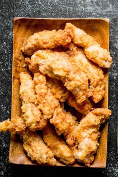 fried chicken in a wooden bowl on a table