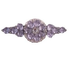 an antique brooch with amethorate and diamonds