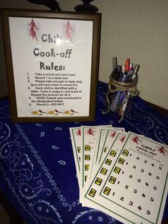 four cards are sitting on a table next to a framed sign