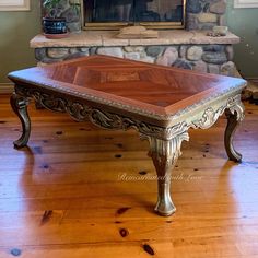 a large wooden table sitting in front of a fire place on top of a hard wood floor