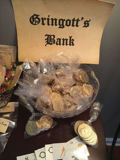 a bunch of coins sitting on top of a table next to a sign that says, bringworth's bank