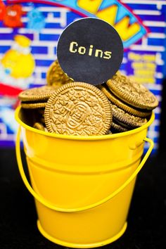 a bucket full of cookies with a sign that says coins