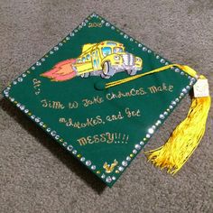 a green graduation cap with a school bus on it