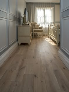 a bedroom with white walls and wood floors is pictured in this image from the doorway