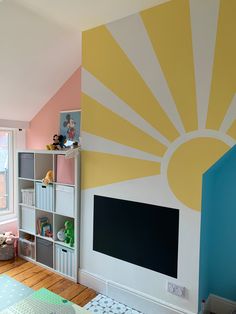 A sun painted on the chimney breast with a chalkboard underneath. Baby pink in one alcove, baby blue in the other. Kids Wall Paint Ideas, Sunshine Mural, Playroom Mural Ideas, Bright Kids Bathroom, Bright Playroom, Yellow Kids Rooms, Bright Kids Room, Childrens Ministry Decor, Kids Church Rooms