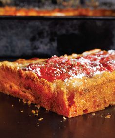 a deep dish pizza with sauce and parmesan cheese