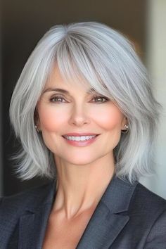 Save this pin for the best medium-length hairstyles for women over 50 with bangs. Playful yet refined, this breezy bob stands out with its wispy texture. Feathery bangs blend seamlessly into the layers, providing a soft frame for the face. Feathery Bangs, Hair 2025