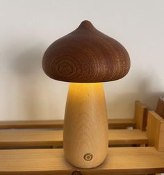 a wooden mushroom lamp sitting on top of a table