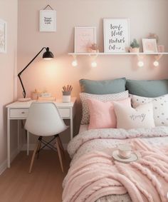 a bedroom with pink walls, white furniture and pictures on the wall above the bed