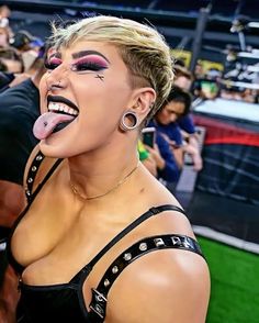 a woman sticking out her tongue at a sporting event