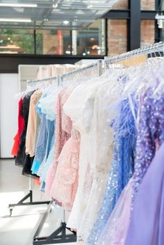 Homecoming dresses showcased on a clothing rack.