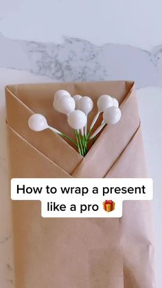 an envelope with flowers in it and the text how to wrap a present like a pro