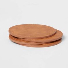 three leather coasters on a white background