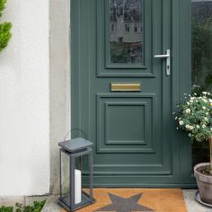 a black door with a star rug on it and a lantern in front of it