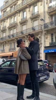 a man standing next to a woman on the street