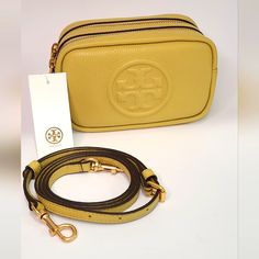 Brand New Tory Burch Perry Bombe Mini Bag In Cornbread Yellow No Flaws No Dustbag Fits All Phone Sizes Up To An Iphone 13 Pro Max And Samsung Galaxy Note 20 Pebbled Leather Zipper Closures Adjustable, Removable Crossbody Strap With 23.1" (58 Cm) Drop 1 Exterior Pocket, 1 Interior Slit Pocket Height: 4.6" (11.5 Cm); Length: 7" (17.5 Cm); Depth: 2.7" (6.8 Cm) Tory Burch Perry Bombe Mini Bag, Tory Burch Crossbody Bag, Tory Burch Purse, Tory Burch Crossbody, Tory Burch Handbags, Crossbody Bag Women, Handbag Straps, Tory Burch Bag, Leather Zipper