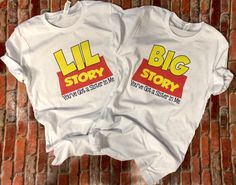 two t - shirts with the words'lil story'printed on them sitting on a brick floor