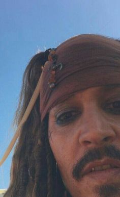 a close up of a person wearing a pirate hat