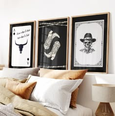 three framed pictures hang on the wall above a bed