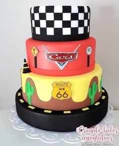 a three tiered cake with cars on it's sides and the number 66