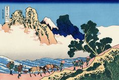 an image of people riding horses and carts on a mountain trail in front of snow capped mountains