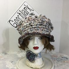 a white mannequin head with a hat on it