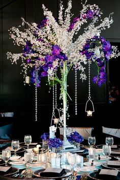 the centerpiece is decorated with purple and white flowers