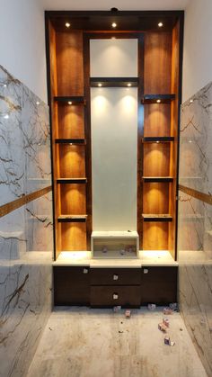 an empty bathroom with marble walls and shelves