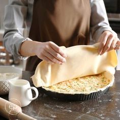 a person is making a pie in the kitchen