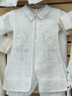 religious symbols  cross on the front of stola .  The item is affordable in price made with a shantung fabric.  The outfit provides the elegance yet gives the child the comfort on that very spacial day.  This out fit can also COULD USE for a ring bearer in a wedding or any other formal occasion.  Comfort, price, and quality is what we guarantee. COLORS: - White - Ivory We carry the following size: - 6 months - 12 months - 24 months  2T-3T  IF YOU HAVE QUESTIONS? We are always available to answer your questions,   please send us a messa White Embroidered Baptism Dress For First Communion, Cream Long Sleeve Baptism Set, White Embroidered Baptism Sets, White Embroidered Sets For Baptism, Traditional White Baptism Sets, Baby Boy Christening, Baptism Outfit, Boy Christening, Religious Symbols