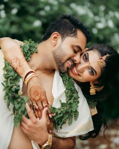 a man and woman are hugging each other