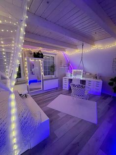 a bedroom decorated in white and purple lights