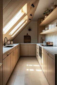 an attic kitchen with wooden cabinets and white counter tops, along with skylights in the ceiling