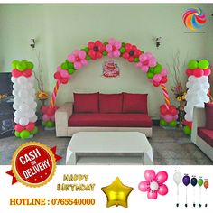 a living room decorated with balloons, flowers and streamers for a birthday or other special occasion