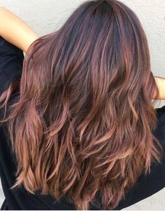 A pale rose hue warms up any brunette base, and this style is heavy on the balayage towards the ends for a naturally sun-kissed look. #haircolorideas #haircolor #hairdyeideas #rosegoldhair #brownhair #southernliving Subtle Rose Gold Balayage Brunette, Brown Hair With Pink Balayage, Dark Rose Gold Hair Brown, Rose Brown Highlights, Rose Brown Balayage, Rose Brown Hair, Balayage Hair Rose, Rose Gold Hair Brunette