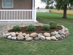 a rock garden bed in front of a house