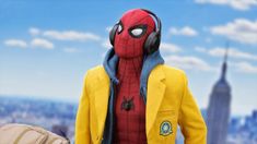 a spider - man with headphones on is standing in front of a cityscape